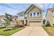 Charming home featuring neat landscaping, a two-car garage, and a cozy, inviting facade at 10004 Perth Moor Rd, Charlotte, NC 28278