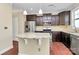 Modern kitchen featuring granite countertops, stainless steel appliances, and dark wood cabinets at 10004 Perth Moor Rd, Charlotte, NC 28278