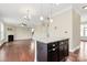 Open-concept kitchen with granite countertops, stainless steel appliances, and a kitchen island at 10004 Perth Moor Rd, Charlotte, NC 28278