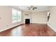 Bright living room with wood floors, a cozy fireplace, and plenty of natural light at 10004 Perth Moor Rd, Charlotte, NC 28278