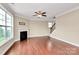 Spacious living room featuring a fireplace, hardwood floors and staircase at 10004 Perth Moor Rd, Charlotte, NC 28278