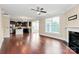 Spacious living room featuring hardwood floors, a cozy fireplace, and abundant natural light at 10004 Perth Moor Rd, Charlotte, NC 28278