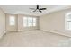 Large primary bedroom featuring a ceiling fan and lots of natural light at 10004 Perth Moor Rd, Charlotte, NC 28278
