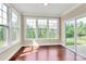 Inviting sunroom featuring walls of windows and sliding glass door to the backyard patio at 10004 Perth Moor Rd, Charlotte, NC 28278