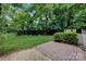 Backyard with a brick patio area and lush green space at 1006 Covewood Ct, Charlotte, NC 28270