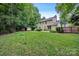 Expansive backyard with green grass and partial house view at 1006 Covewood Ct, Charlotte, NC 28270