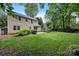 Large backyard featuring a well-maintained lawn and a view of the home's exterior at 1006 Covewood Ct, Charlotte, NC 28270