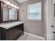 Bathroom with gray tile floor, modern vanity and a window at 1006 Covewood Ct, Charlotte, NC 28270