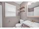 Bathroom featuring a sleek vanity, toilet and a window at 1006 Covewood Ct, Charlotte, NC 28270