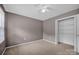 Comfortable bedroom featuring neutral walls, carpet, a ceiling fan, and a closet at 1006 Covewood Ct, Charlotte, NC 28270