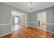 Open dining room featuring hardwood floors and a view to kitchen and living areas at 1006 Covewood Ct, Charlotte, NC 28270