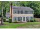 Charming two-story home with a brick chimney and manicured landscaping, perfect for Gathering living at 1006 Covewood Ct, Charlotte, NC 28270