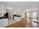 The open-concept kitchen features white cabinets, black countertops, and a seamless flow to the living area at 1006 Covewood Ct, Charlotte, NC 28270