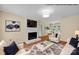 Digitally staged living room showcases hardwood floors, a fireplace, and an open layout to the dining area at 1006 Covewood Ct, Charlotte, NC 28270