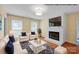 Digitally staged living room features a white fireplace, hardwood floors, and a cozy seating arrangement at 1006 Covewood Ct, Charlotte, NC 28270