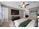 Staged main bedroom with a ceiling fan, private bathroom and a TV on the wall at 1006 Covewood Ct, Charlotte, NC 28270