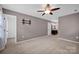 Spacious carpeted main bedroom with an ensuite bathroom and ceiling fan at 1006 Covewood Ct, Charlotte, NC 28270