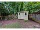 Backyard shed that is surrounded by a wooden fence at 1006 Covewood Ct, Charlotte, NC 28270