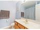 Bright bathroom featuring a vanity with white countertop, wood cabinets, and a shower with blue checkered curtain at 1108 Plaza Walk Dr, Charlotte, NC 28215