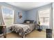 Comfortable bedroom with two windows, light-blue walls, and modern decor at 1108 Plaza Walk Dr, Charlotte, NC 28215