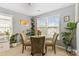 Bright dining area with a glass table, comfortable seating, and natural light at 1108 Plaza Walk Dr, Charlotte, NC 28215