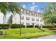 Beautiful exterior of a multi-story home with manicured lawn and mature trees at 1108 Plaza Walk Dr, Charlotte, NC 28215