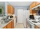 Well-equipped kitchen with wooden cabinets, stainless steel appliances, and ample counter space at 1108 Plaza Walk Dr, Charlotte, NC 28215