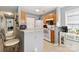 Functional kitchen layout with breakfast bar, white appliances, and modern finishes at 1108 Plaza Walk Dr, Charlotte, NC 28215