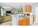 Open-concept living and kitchen area with a breakfast bar and modern amenities at 1108 Plaza Walk Dr, Charlotte, NC 28215