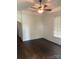 Cozy room featuring hardwood floors, white trim, and a vintage ceiling fan fixture at 1126 Clement Ave, Charlotte, NC 28205