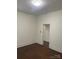 Bedroom features clean walls, wood flooring, and an open doorway to another room at 1126 Clement Ave, Charlotte, NC 28205