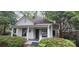 Charming home featuring white siding, a covered porch, and lush green landscaping at 1126 Clement Ave, Charlotte, NC 28205