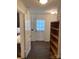 A bright hallway featuring a vintage wooden shelf and doorway to the kitchen at 1126 Clement Ave, Charlotte, NC 28205