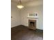 Cozy living room featuring a brick fireplace and hardwood floors and a door to another room at 1126 Clement Ave, Charlotte, NC 28205