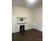 Inviting living room showcasing a decorative fireplace with vintage hardwood floors at 1126 Clement Ave, Charlotte, NC 28205