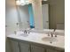 Bathroom featuring a double sink vanity with two mirrors and neutral fixtures, offering ample countertop space at 1201 Forest Ridge Rd, Bessemer City, NC 28016