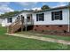 Charming home featuring black shutters and a wooden porch in a well-manicured lawn at 1201 Forest Ridge Rd, Bessemer City, NC 28016