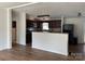 Open kitchen with dark cabinets, granite counters, and a breakfast bar at 1201 Forest Ridge Rd, Bessemer City, NC 28016