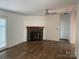 Spacious living room with a stone fireplace and modern ceiling fan at 1201 Forest Ridge Rd, Bessemer City, NC 28016