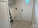 Utility room featuring tile flooring, upper cabinets, a diamond window door and a ladder for easy maintenance at 1201 Forest Ridge Rd, Bessemer City, NC 28016
