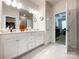 Bathroom featuring double sinks, white cabinets, and a large mirror, along with tile floors at 1211 Calder Dr, Indian Trail, NC 28079