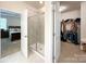 Modern bathroom view featuring a walk-in shower, access to a walk-in closet, and a bedroom at 1211 Calder Dr, Indian Trail, NC 28079