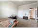 Bedroom with beige carpet, neutral paint, a table and decor, and view to en-suite bathroom at 1211 Calder Dr, Indian Trail, NC 28079