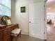 Bright dressing area featuring a vanity next to bedroom door and window at 1211 Calder Dr, Indian Trail, NC 28079