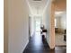 Bright hallway with dark hardwood floors, white trim, and a view of the front door at 1211 Calder Dr, Indian Trail, NC 28079