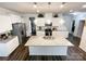 Open kitchen features a large center island, stainless steel appliances and pendant lighting at 1211 Calder Dr, Indian Trail, NC 28079