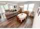 Open living and dining area featuring hardwood floors, a fireplace, and large windows at 1211 Calder Dr, Indian Trail, NC 28079