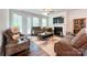 Comfortable living room features a fireplace, ceiling fan, and plenty of natural light at 1211 Calder Dr, Indian Trail, NC 28079