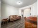 Cozy living room with hardwood floors, a brown sofa, and plenty of natural light at 1211 Calder Dr, Indian Trail, NC 28079