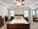 Bright main bedroom with tray ceilings, neutral walls, large bed, and windows with blinds at 1211 Calder Dr, Indian Trail, NC 28079